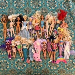 Lot of 28 Assorted plastic dolls in various states of use